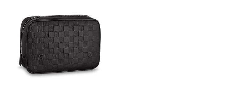 This Louis Vuitton Toletry Pouch in Damier Graphite canvas will protect  your shaving tools and treatments.