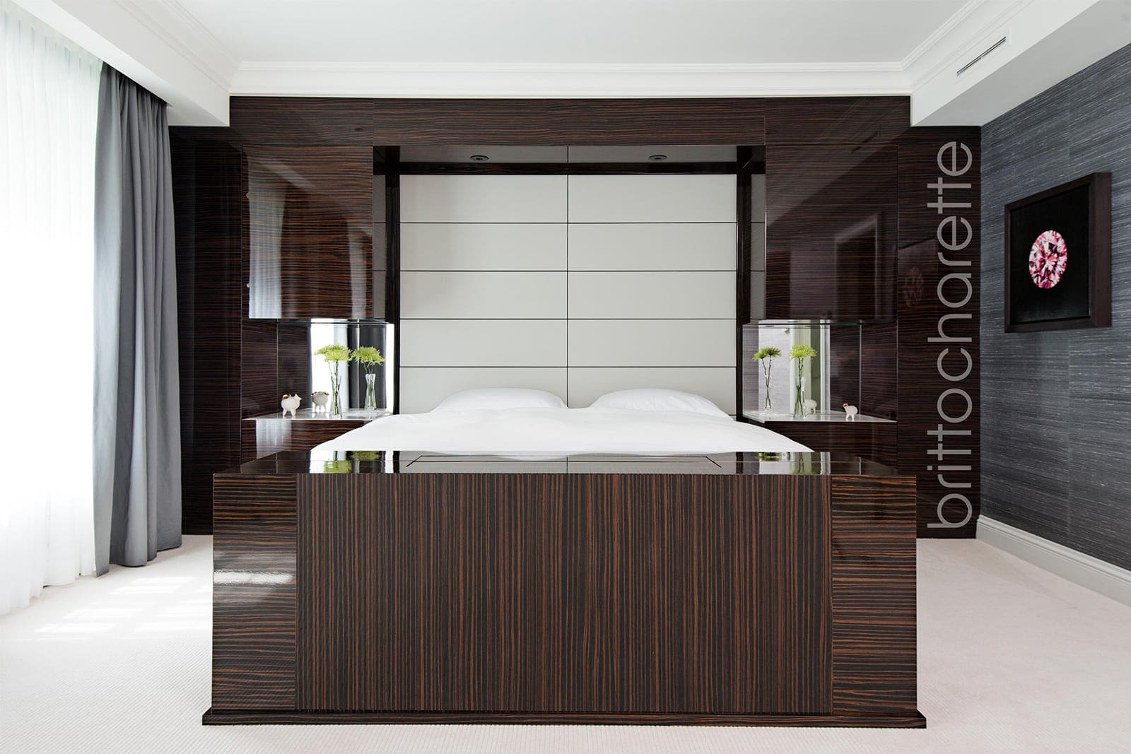 primary bedroom with designed wall